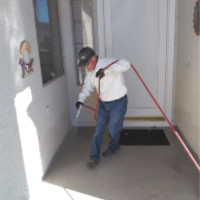 Home Pest Control - Croach - Sumner, WA - Technician spraying for spiders