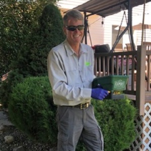 Croach Pest Control Exterminator - Cottonwood Heights, Utah - Smiling as He Treats Outside of Home - 300x300