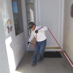 Croach Exterminator Spraying Front Entry of Home - 300x300