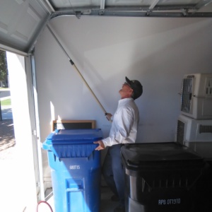 Pest Control Exterminator Working in Garage - 300x300