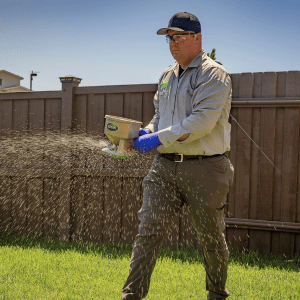 Croach Pest Control Technician Applying Barrier Treatment - Auburn WA