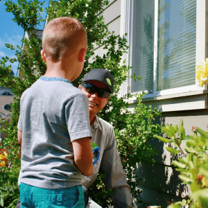 Exterminator Chatting With Homeowners Child About Pest Control - Bellevue WA